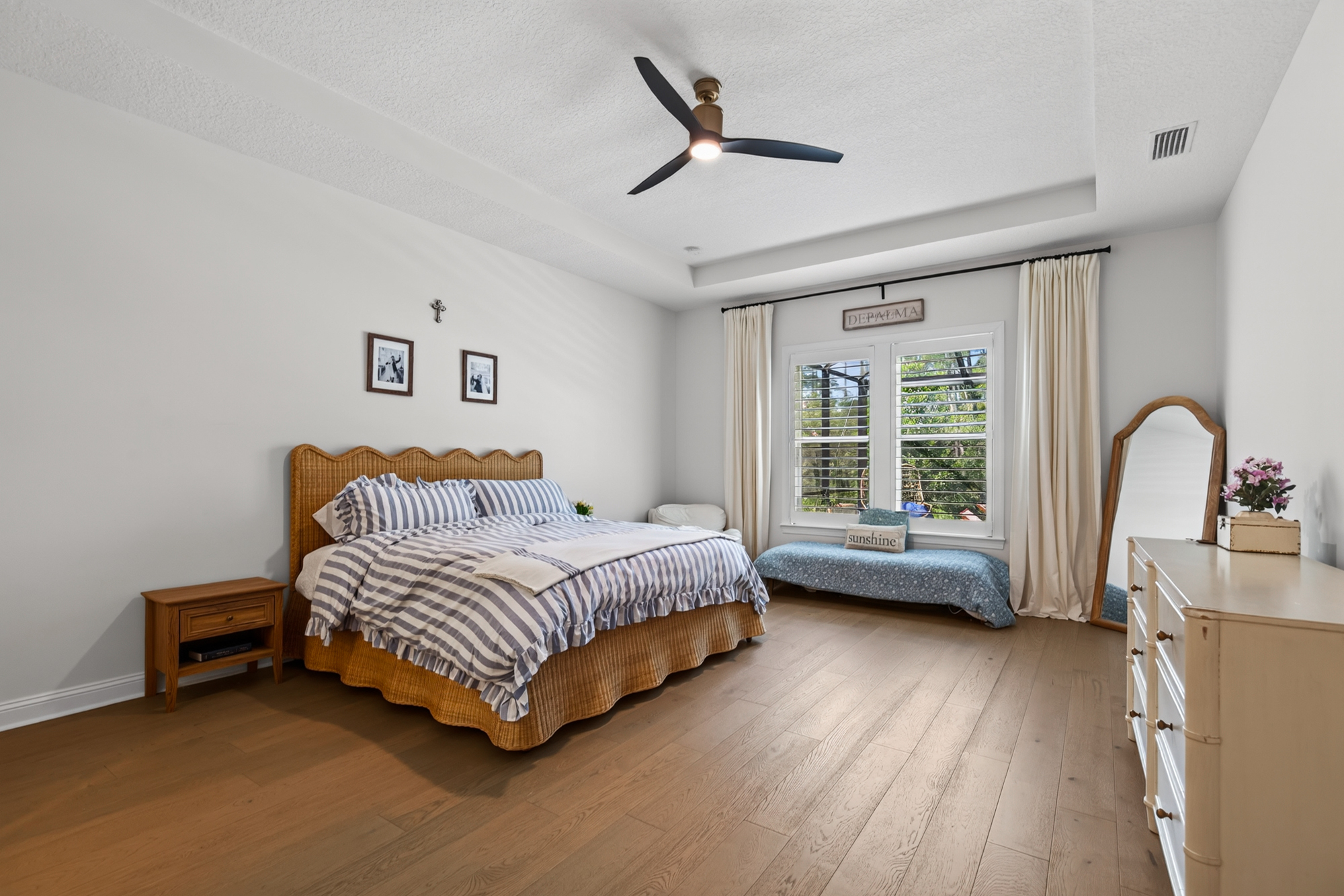 Professional listing photo of a bright Jacksonville primary bedroom
